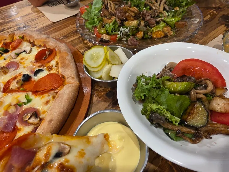 Steak salad served with pizza and pasta