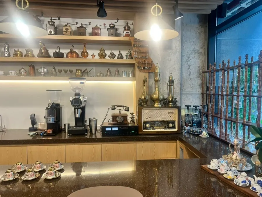Antique hand mills lined up on wall shelving