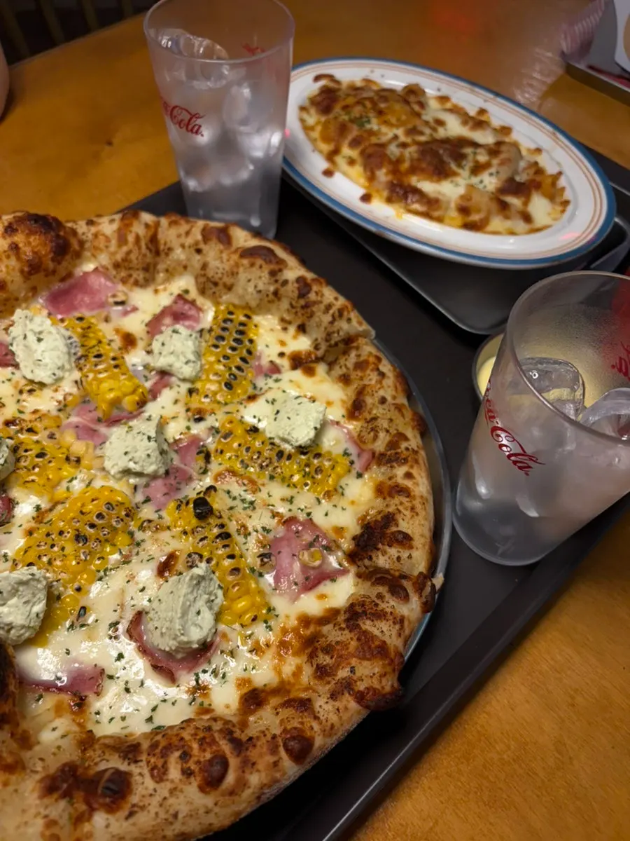 Creamy corn dish served with pizza