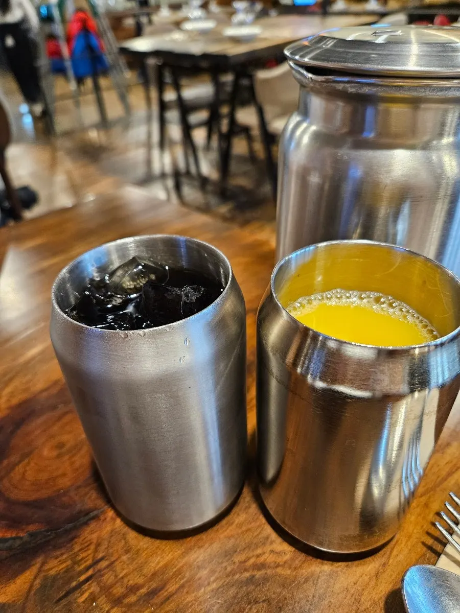 Free drinks at Cultured: zero-sugar cola and tangerine juice