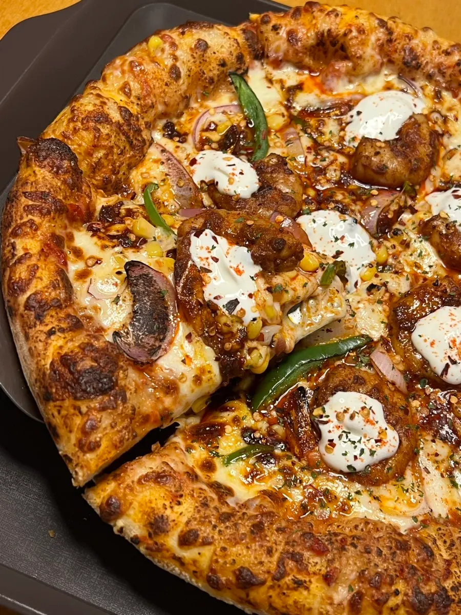 Close-up of whole shrimp and corn toppings