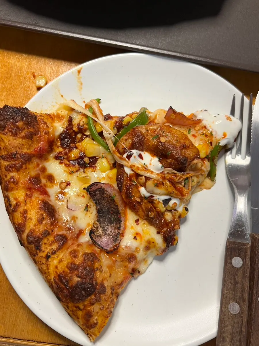 A slice of pizza with stretchy cheese