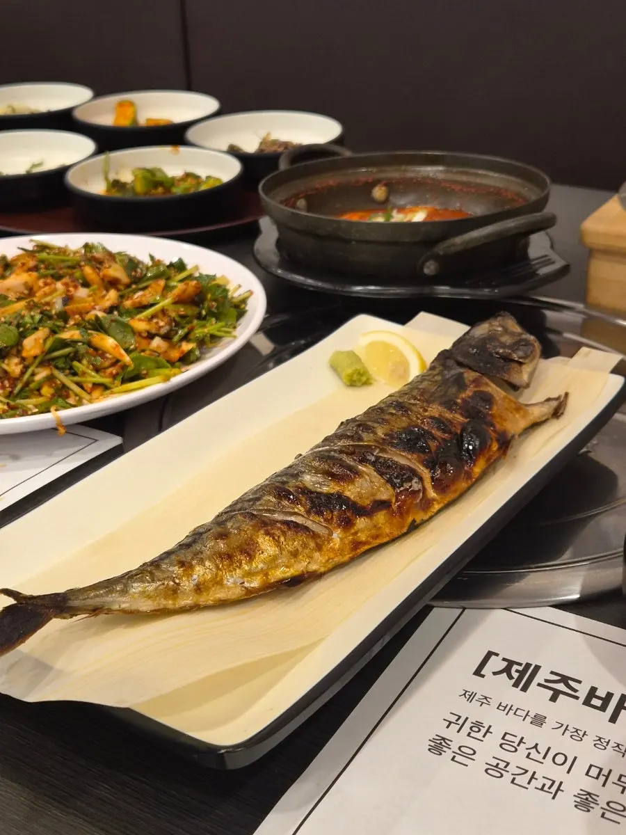 Half portion of grilled mackerel served with lemon and fresh wasabi