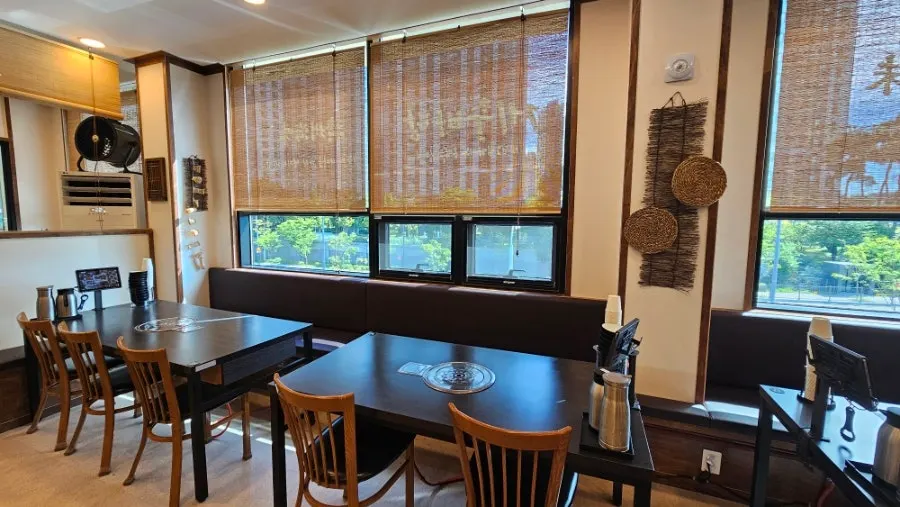 Jeju Badang's 2nd-floor space decorated with basalt stone walls and wood tones