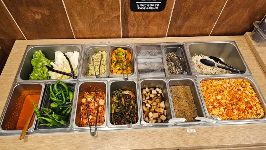 Table with refilled stir-fried pork and side dishes