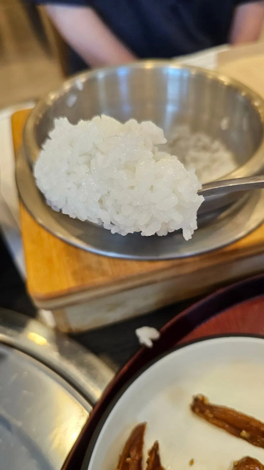 Glossy rice grains in Jeju Badang's pot rice with the lid open