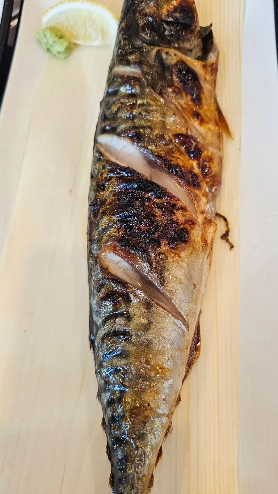 A full spread of grilled fish served with pot rice
