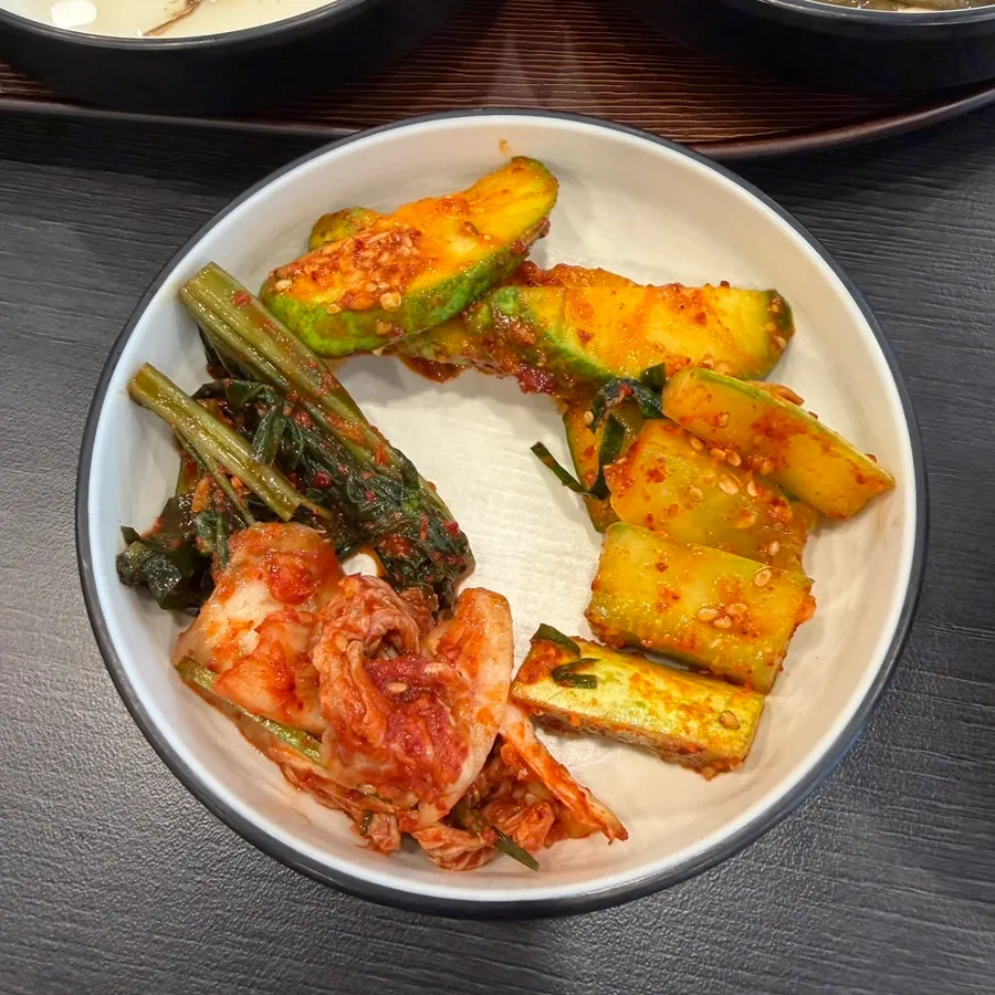 Japchae and other side dishes at the self-serve bar