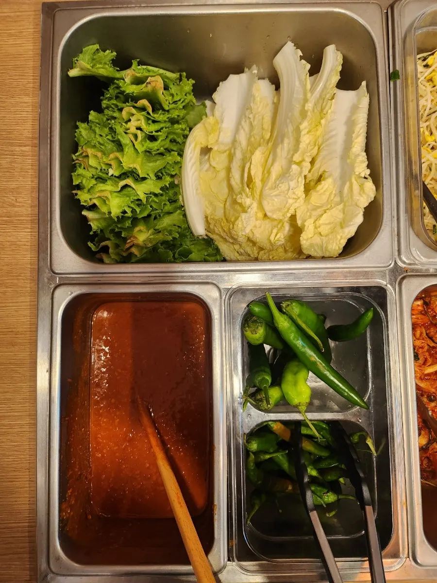 Side dishes set out at Jeju Badang's self-serve bar