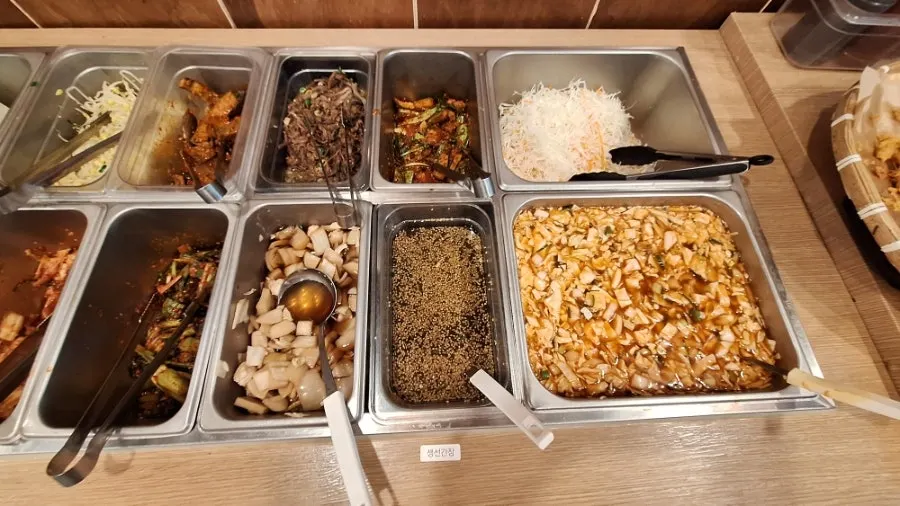 Side dishes and seasoned soy sauce at the self-serve bar