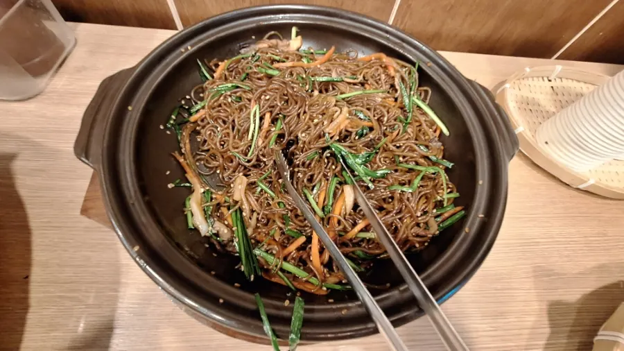 A plate of japchae gathered from the self-serve bar