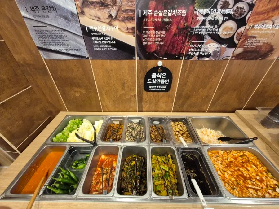 Namul and japchae laid out at the Jeju Badang self-serve bar