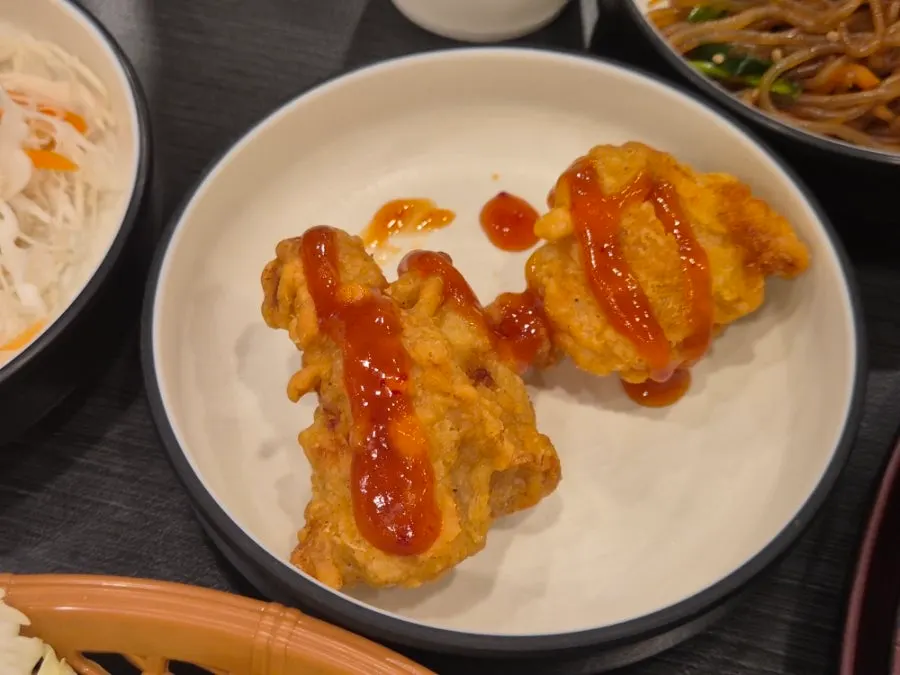 A plate loaded with self-serve bar side dishes