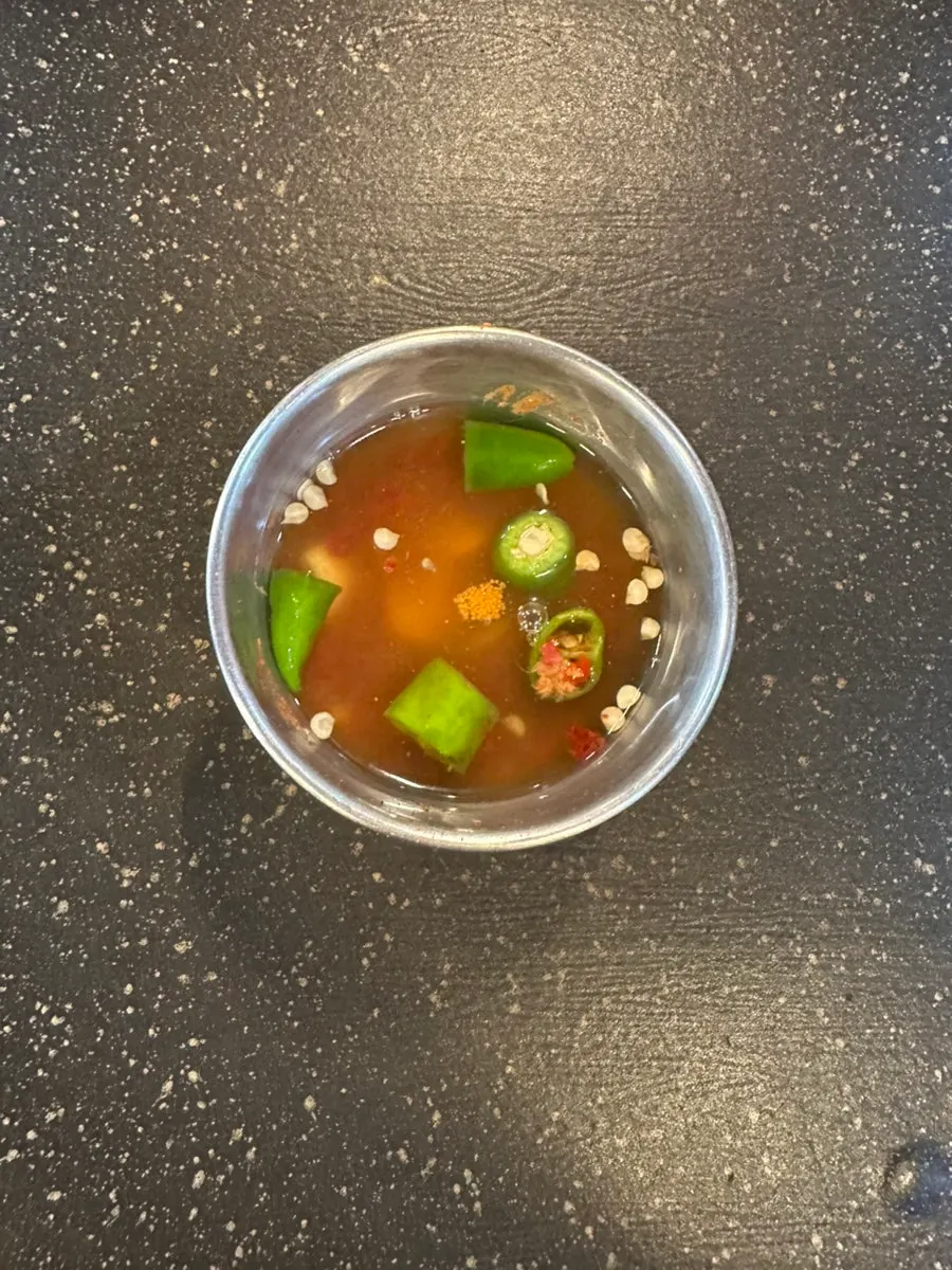 Table set with ssamjang, garlic, and pickled onions