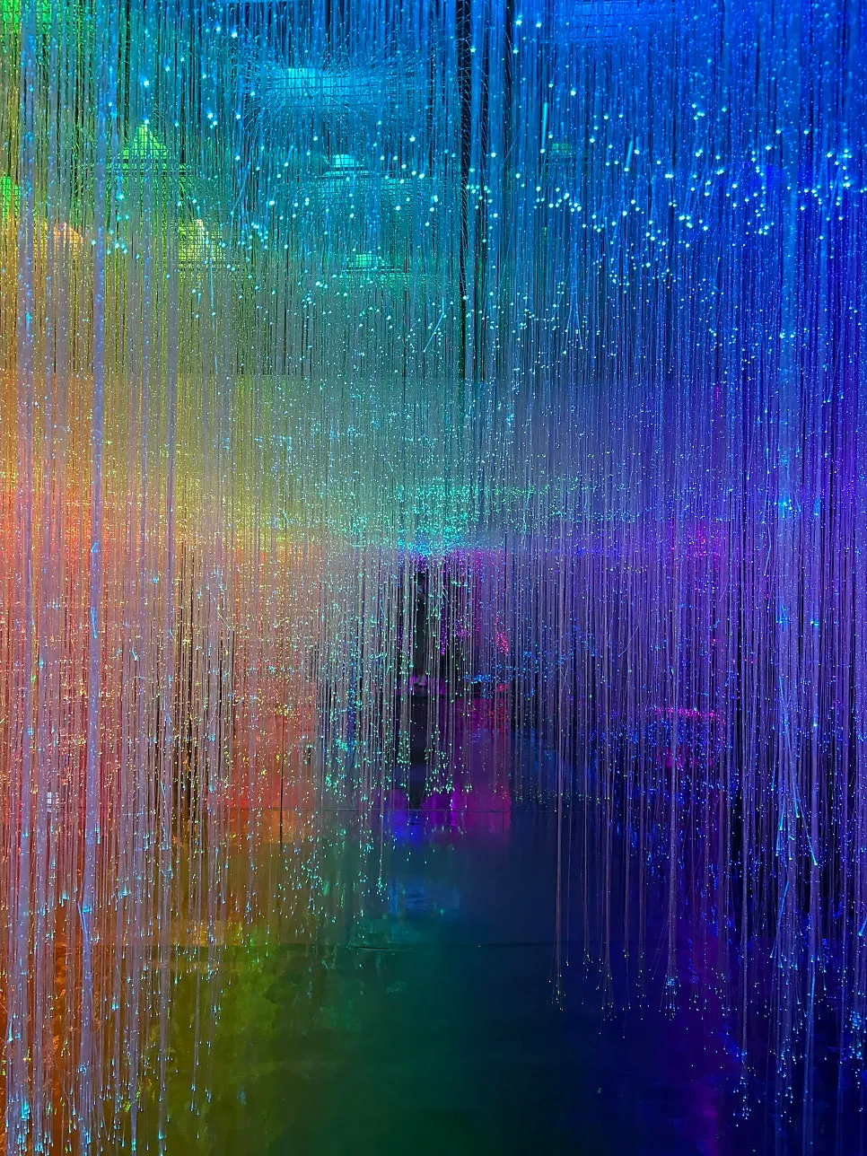 Tunnel of light with rainbow colors pouring down