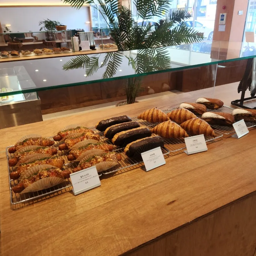 Bakery corner with salt bread and other items at Dobana