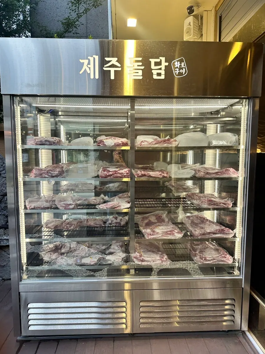 Black pork on display in the entrance fridge