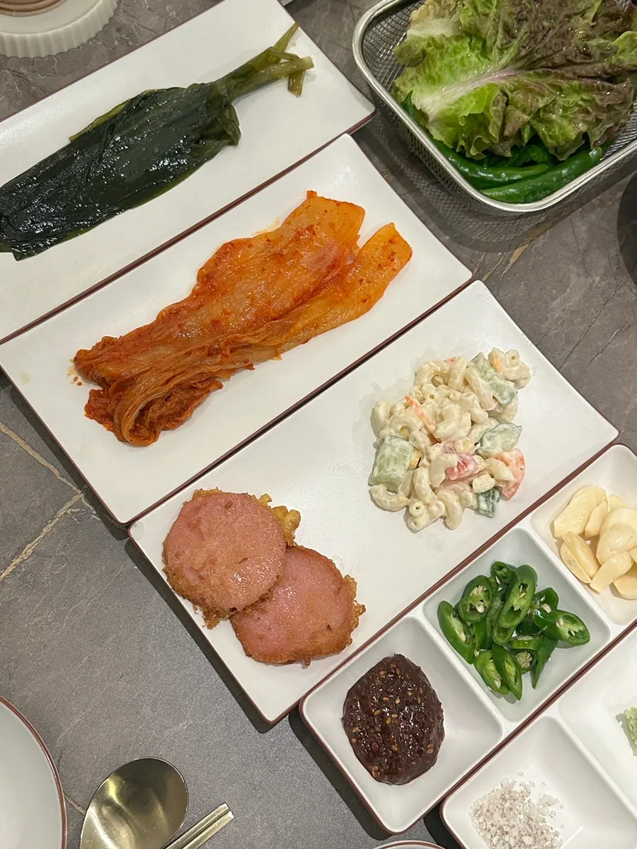 Table setting with lettuce and scallion kimchi banchan
