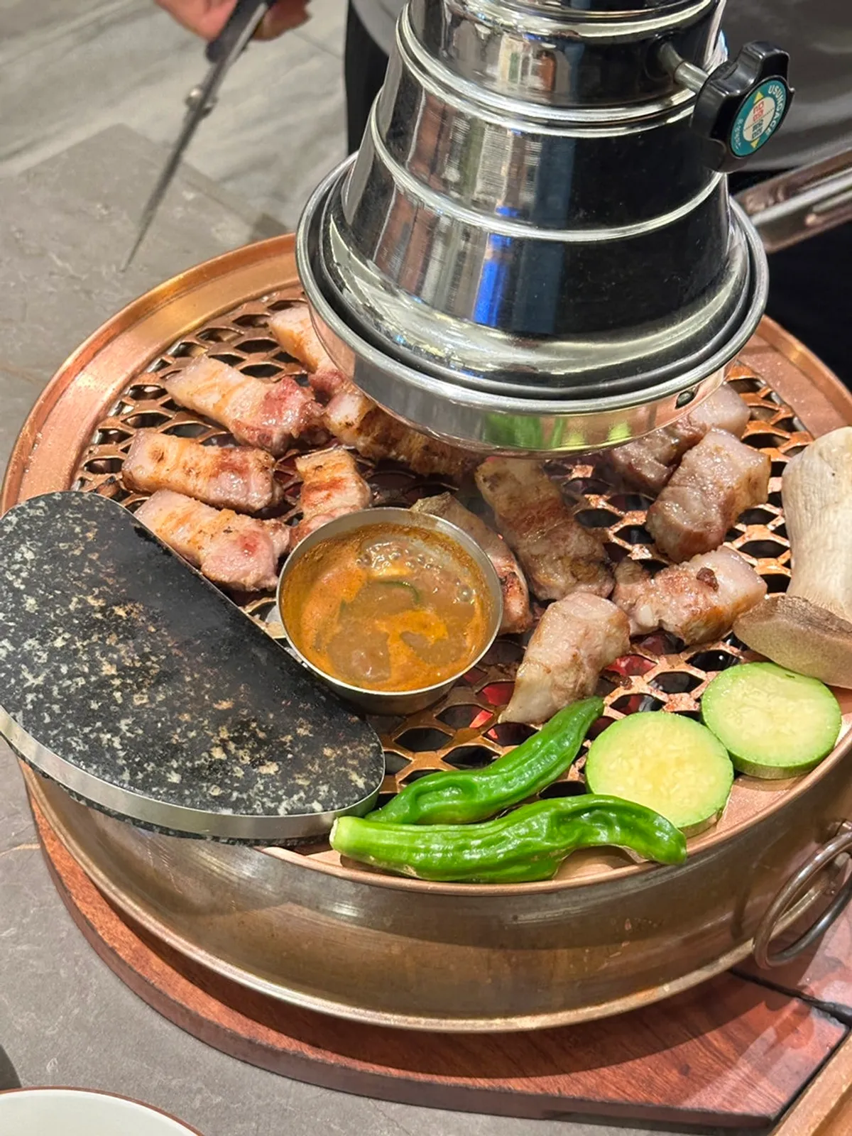 Oegyeopsal turning golden brown over charcoal