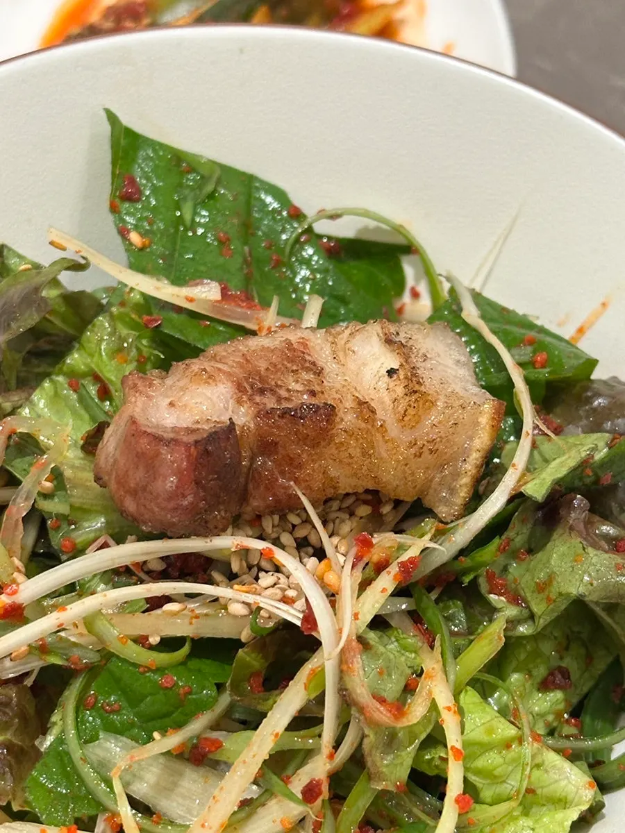 A piece of oegyeopsal dipped in galchisokjeot