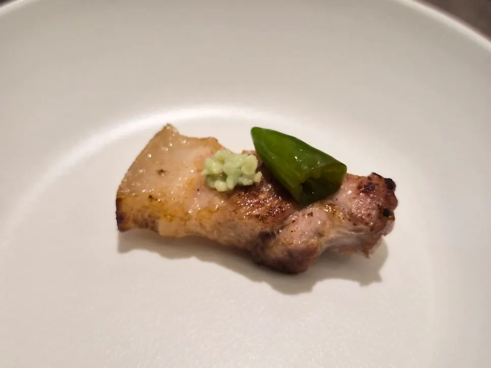 A piece of pork belly wrapped in lettuce
