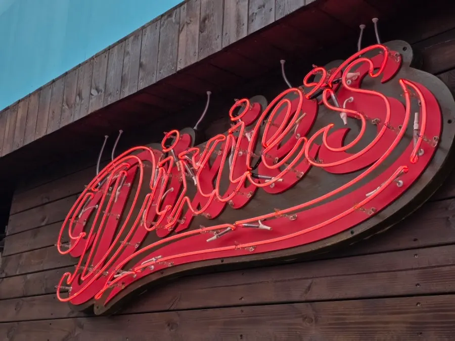 Vintage wood siding and red Dixie's neon sign