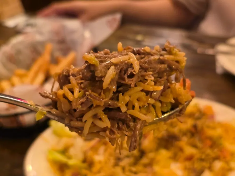 Beef debris rice bowl topped with taco-style ingredients