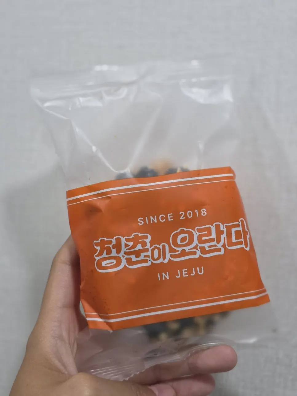 Chocolate-coated donut oranda topped with crushed peanuts