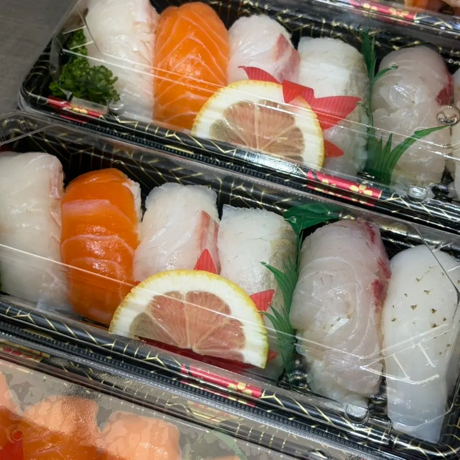 A packed container of assorted sushi for takeout