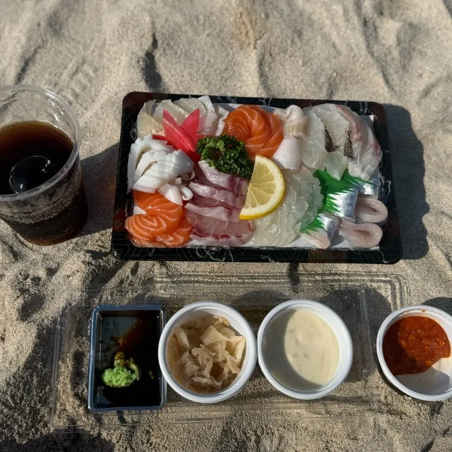 Final view of the sashimi takeout spread set up by the sea