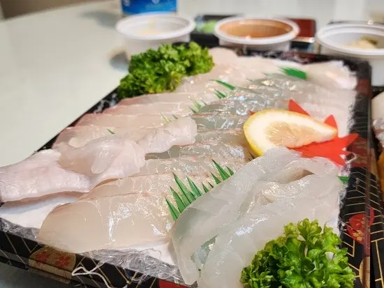 Flatfish sashimi served with soy sauce and wasabi