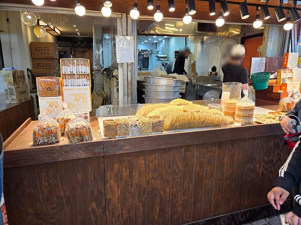 Stall with oranda arranged by type under lighting, with workspace behind