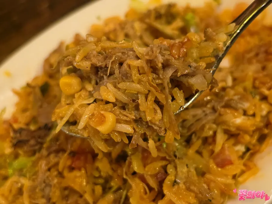 A spoonful of the mixed braised pork bowl