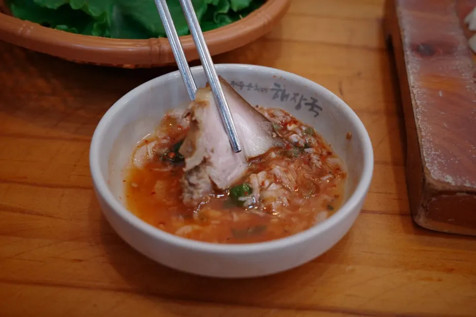 A piece of dombe pork dipped in salted shrimp