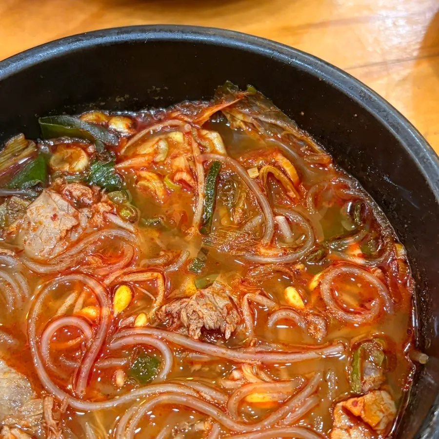 Tripe soup topped with scallions and chili flake seasoning