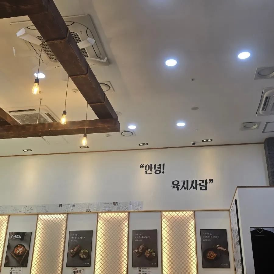 간접조명과 메뉴 사진이 걸린 매장 내부