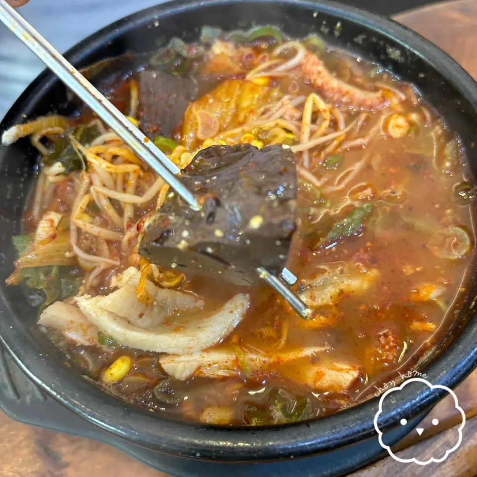 A stone pot of haejangguk topped with chili paste