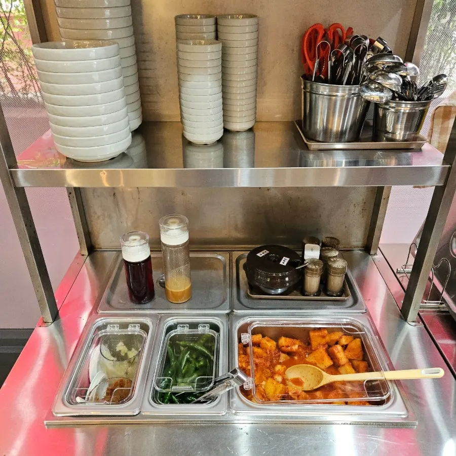 Radish kimchi, dadagi, garlic, and chili peppers at the self-serve bar