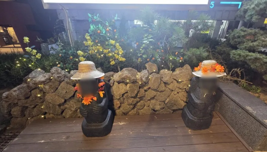 Restaurant entrance decorated with a dol hareubang statue