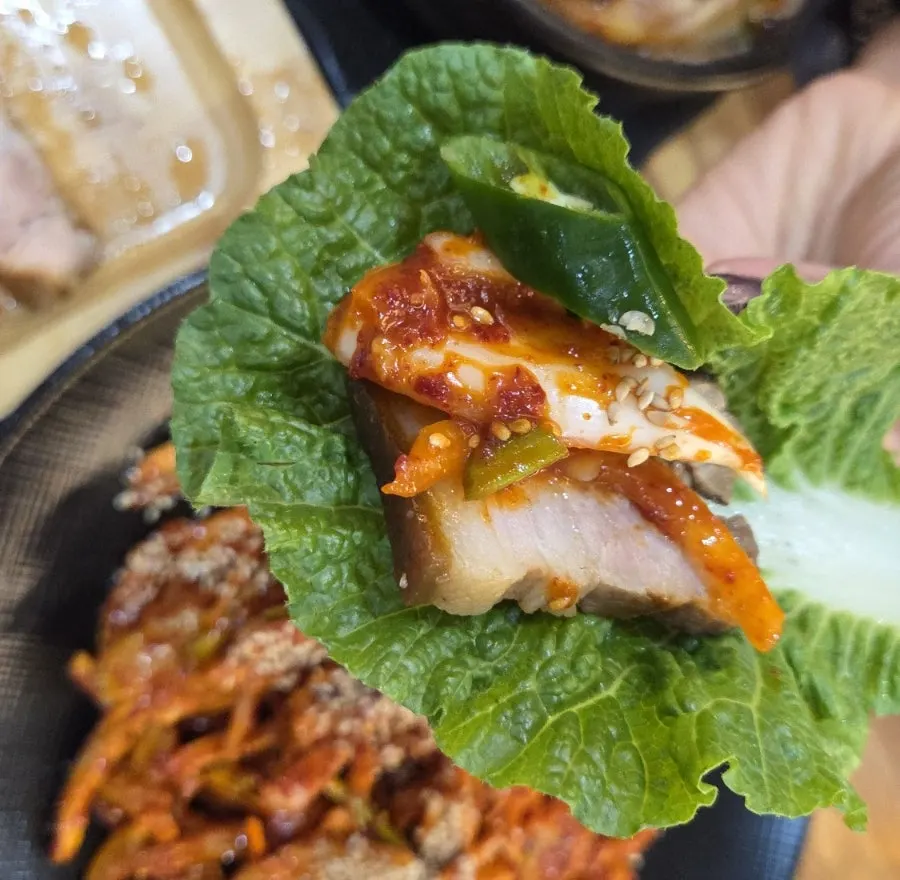 Boiled pork and tripe salad on a lettuce wrap