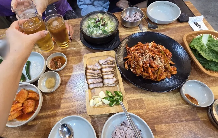 Table set with hangover soup, dombe pork, and tripe salad