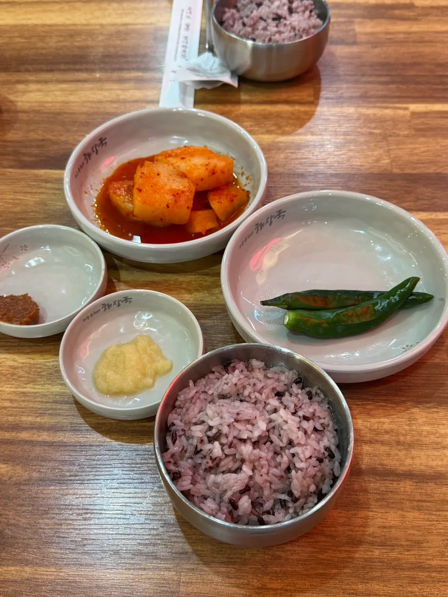 Basic side dishes: kkakdugi, doenjang, minced garlic, and cheongyang chili peppers