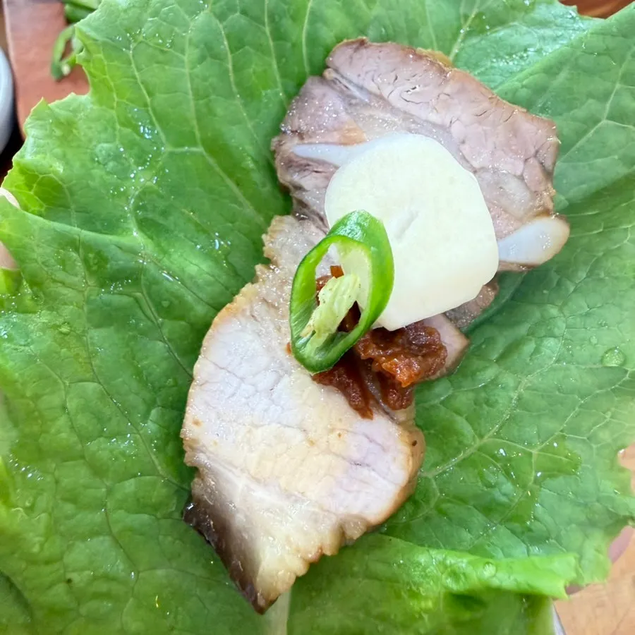 Dombe pork wrapped in a lettuce leaf