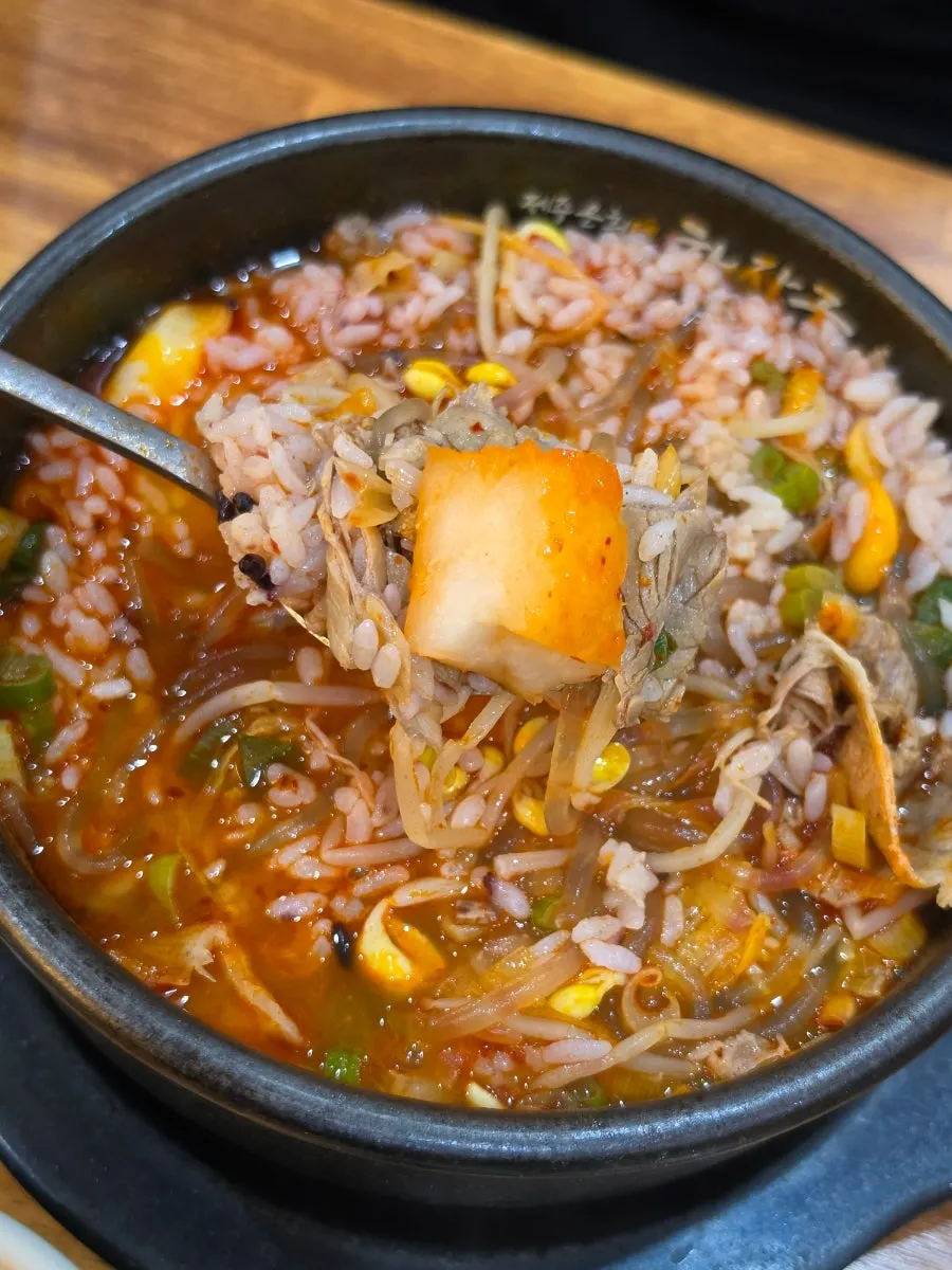 Rice mixed into haejangguk topped with bean sprouts and meat