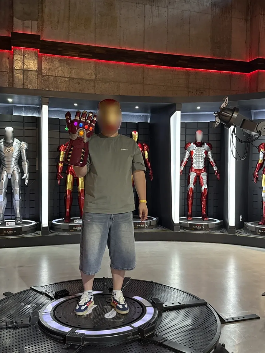 A child trying on hero props