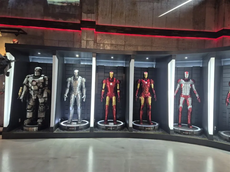 Iron Man suits lined up under the lights