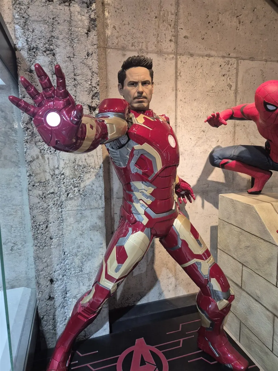 Iron Man with Tony Stark's face and a Spider-Man statue