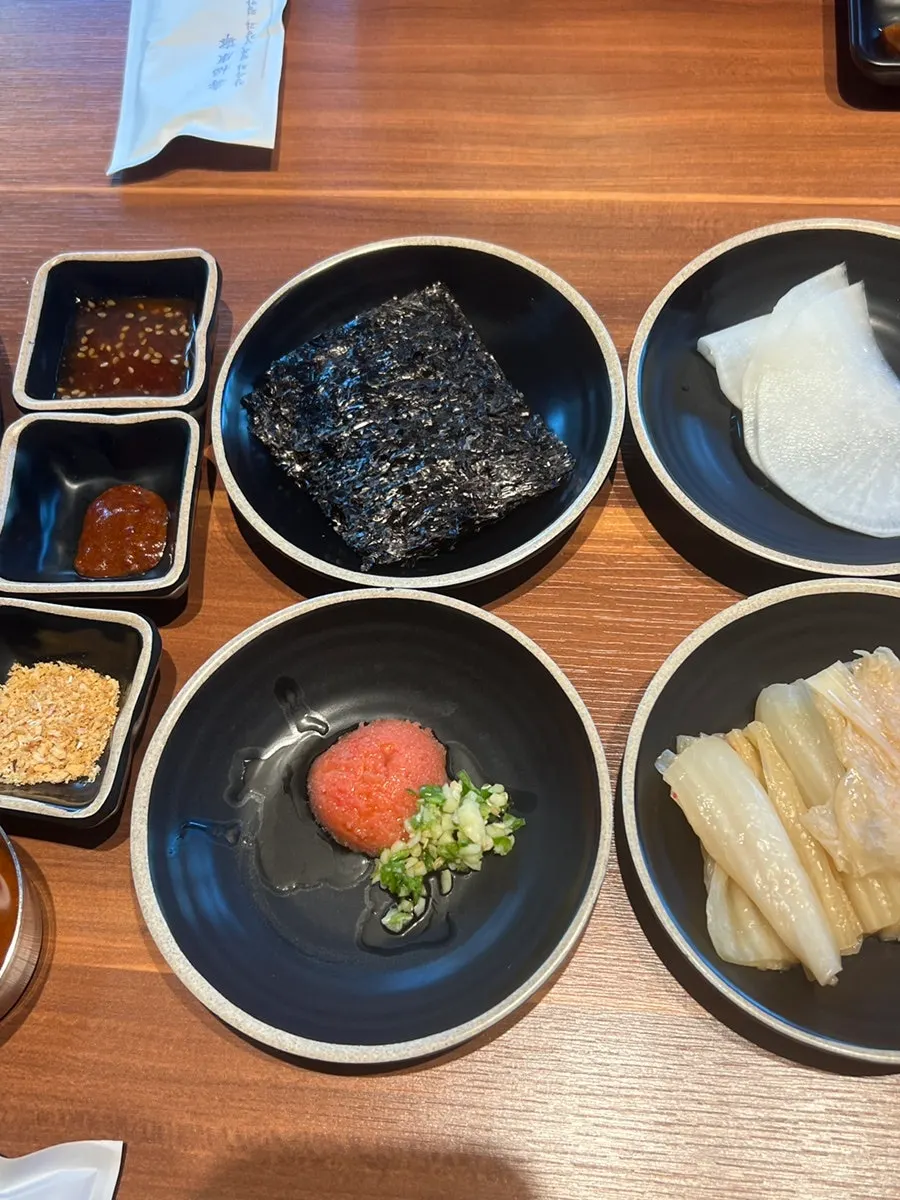 Various sauces served alongside the black pork
