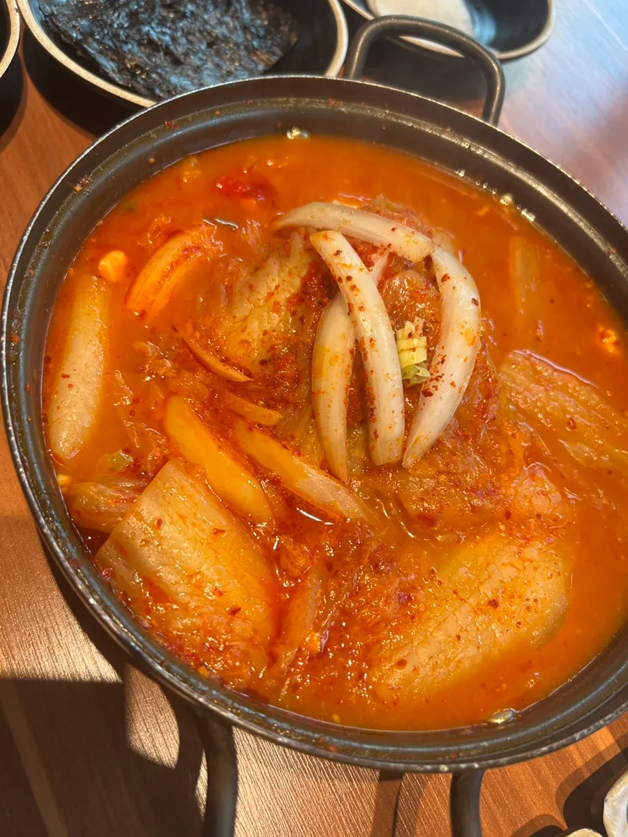 Kimchi jjigae broth served with a bowl of rice