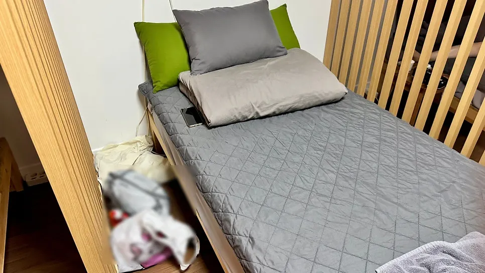 A dorm bed with a 23cm mattress